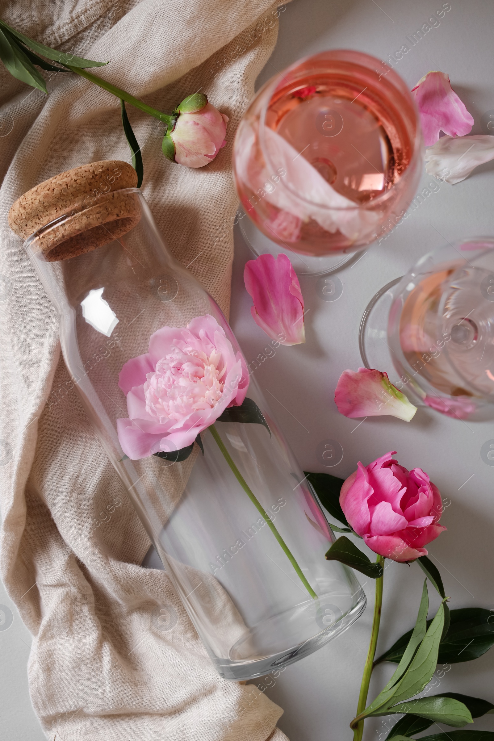 Photo of Flat lay composition with rose wine and beautiful pink peonies on white background