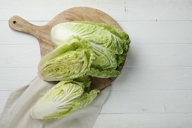 Photo of Fresh ripe Chinese cabbages on white wooden table, flat lay. Space for text