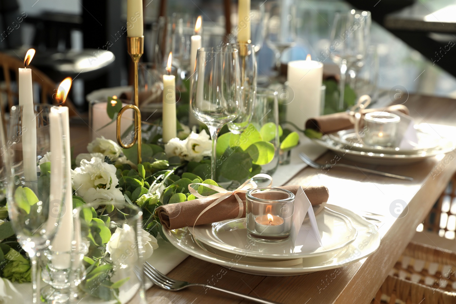 Photo of Elegant table setting with beautiful floral decor and burning candle