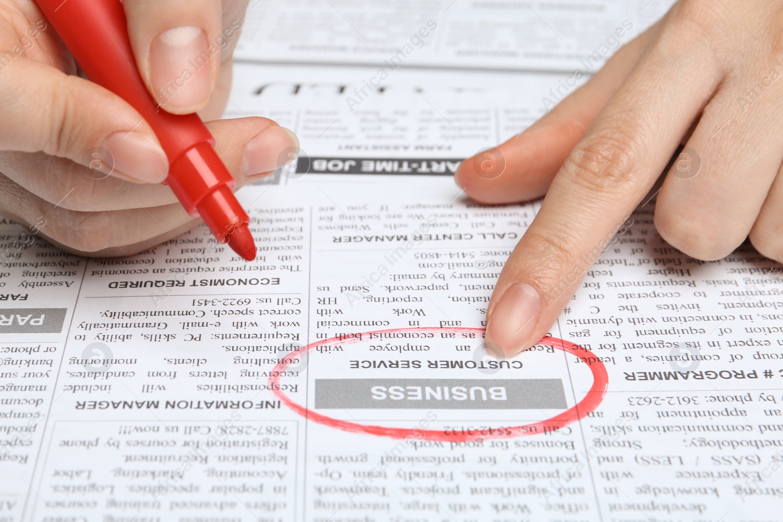 Photo of Woman marking advertisement in newspaper, closeup. Job search concept