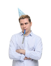 Sad young man with party hat and blower on white background