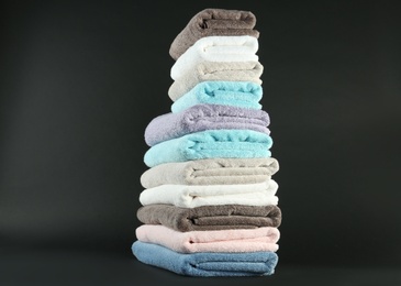 Different fresh soft terry towels on dark background