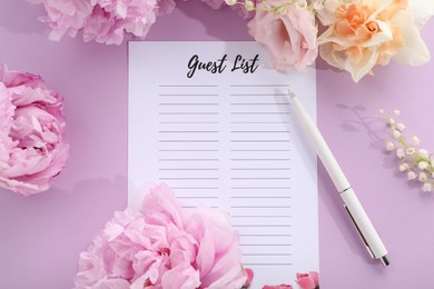 Guest list, pen and beautiful flowers on violet background, flat lay. Space for text