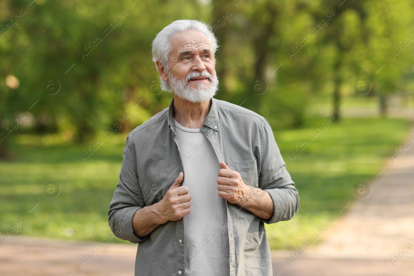 Photo of Portrait of happy grandpa in spring park