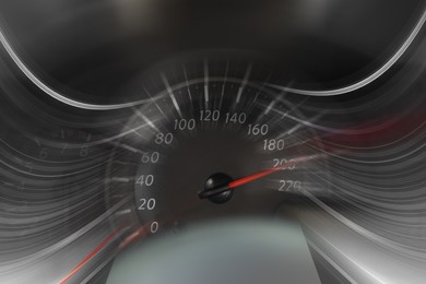 Speedometer on dashboard in car, motion blur effect
