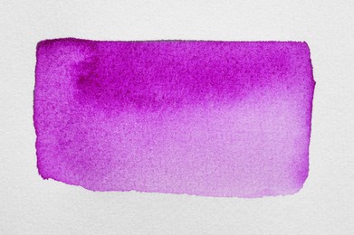 Photo of Rectangle drawn with purple watercolor paint on white background, top view
