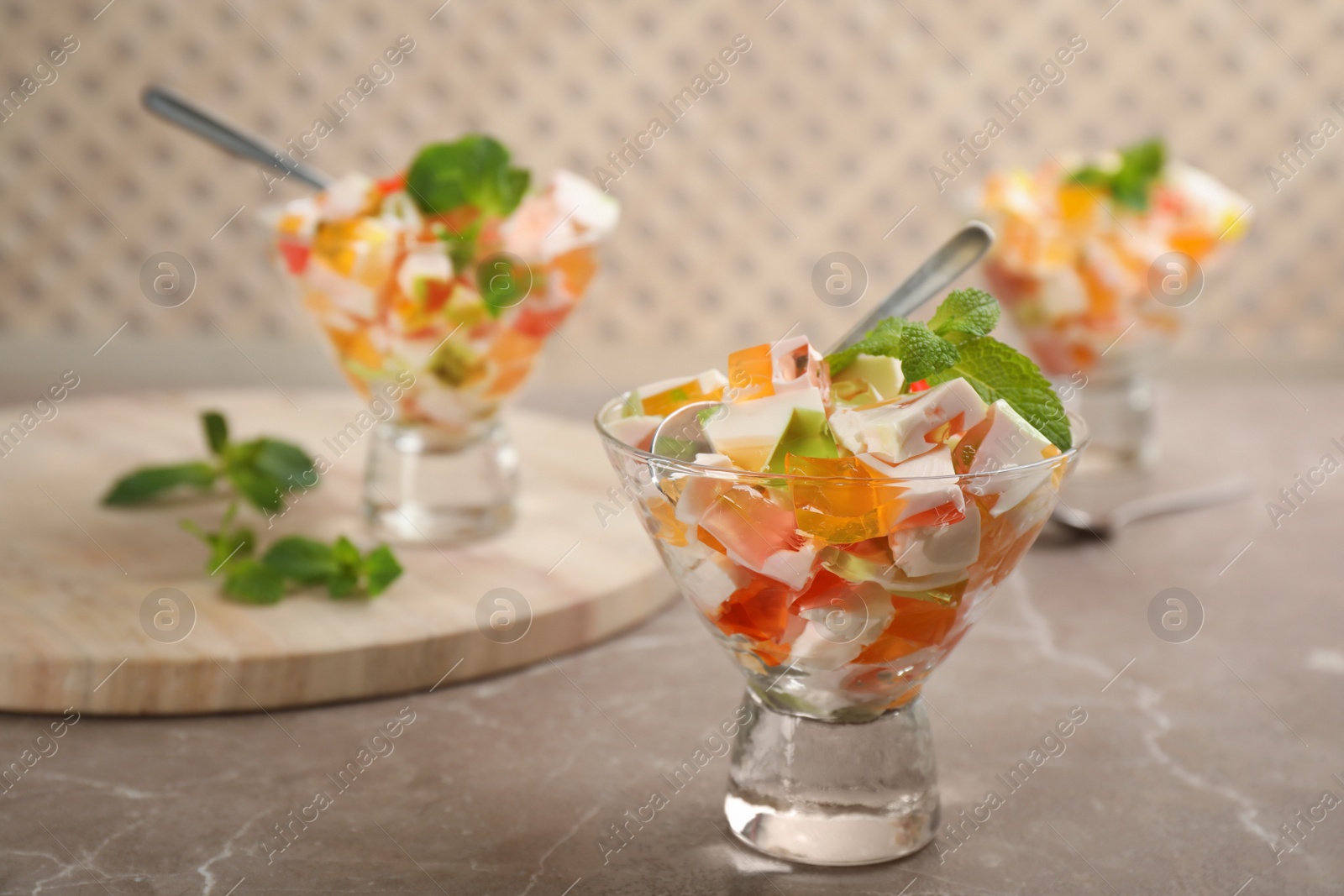 Photo of Delicious broken glass jelly dessert on table, space for text