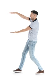 Man in casual clothes holding something on white background