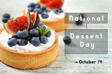 Image of National Dessert Day, October 14. Tasty tartlets with blueberries and figs on white wooden table, closeup