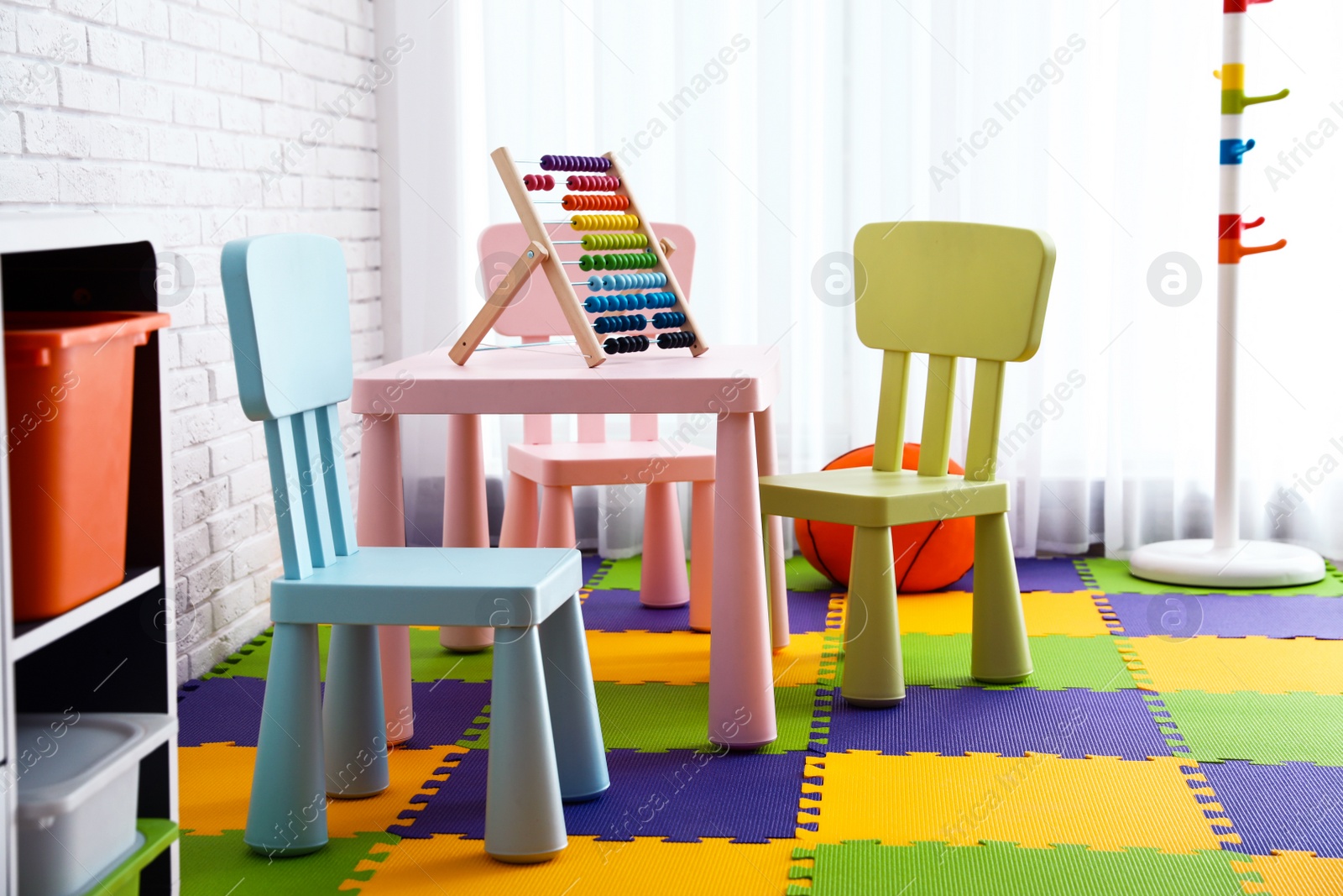 Photo of Stylish playroom interior with toys and modern furniture