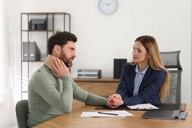 Photo of Injured man having meeting with lawyer in office