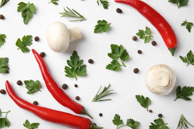 Flat lay composition with green parsley, rosemary, pepper and mushrooms on white background