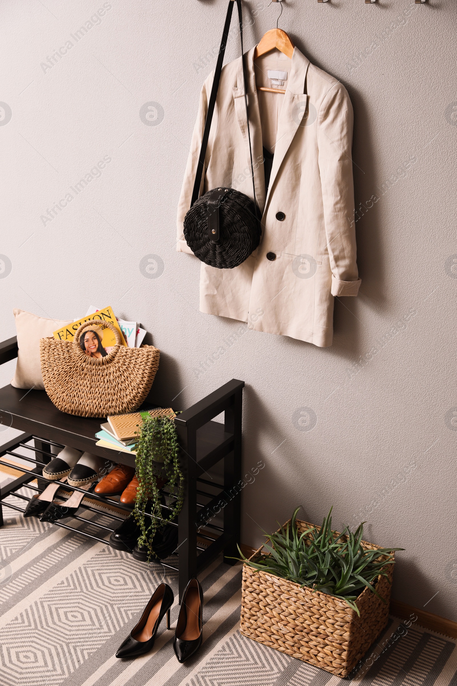 Photo of Hallway interior with stylish furniture, clothes and accessories