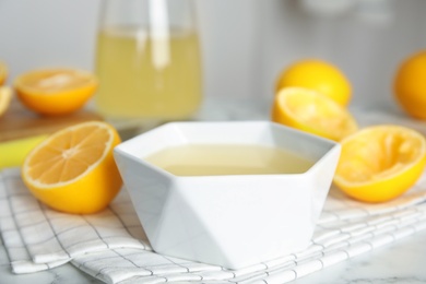 Freshly squeezed lemon juice in bowl on table