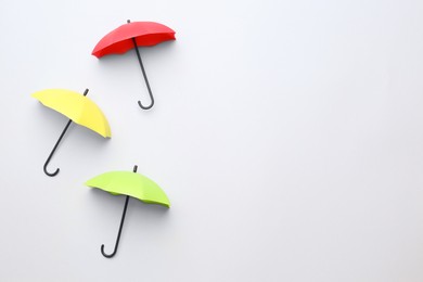 Photo of Different umbrellas on white background, top view. Space for text