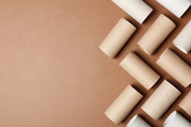 Photo of Flat lay composition with empty toilet paper rolls and space for text on color background