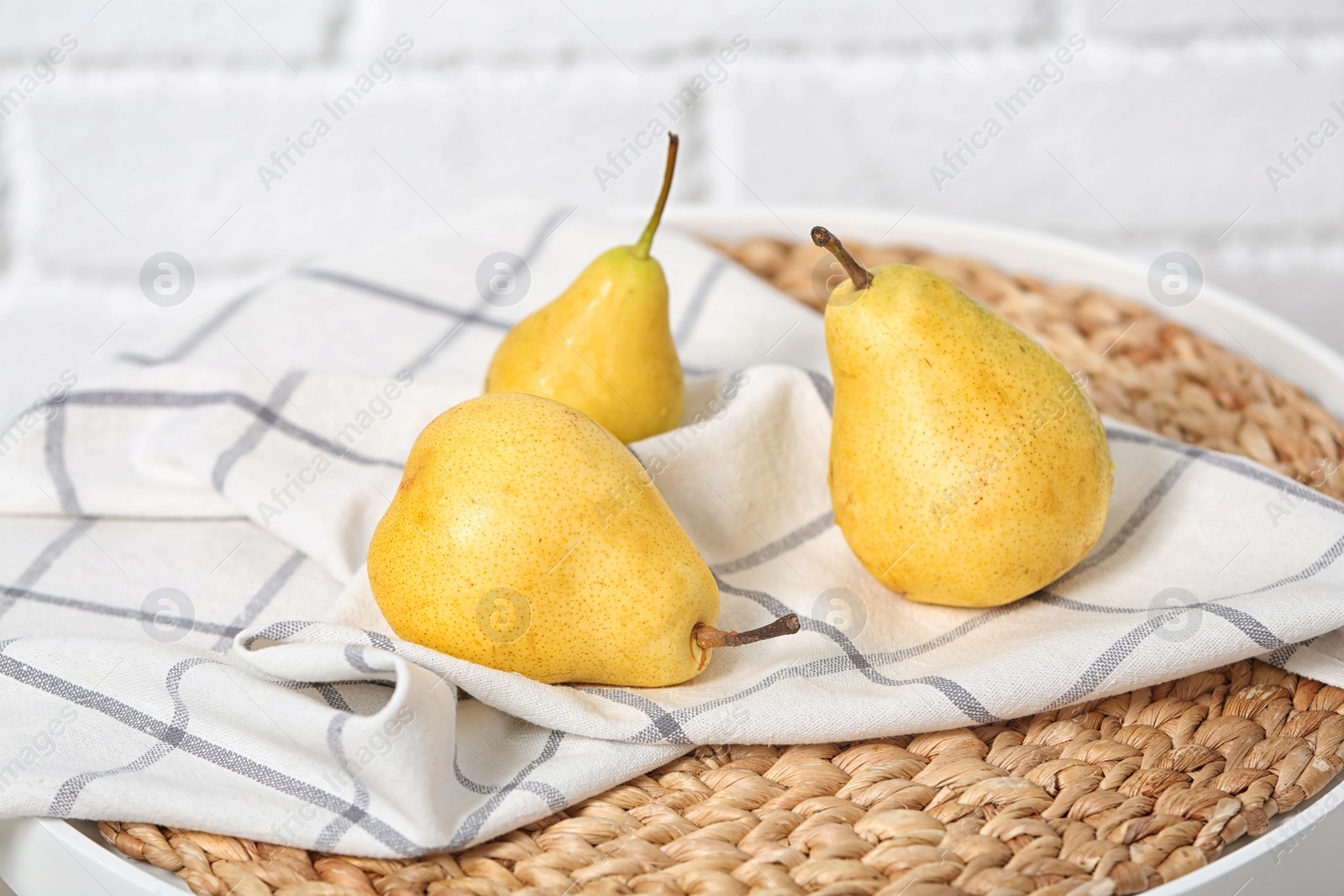 Photo of Ripe pears on table near brick wall