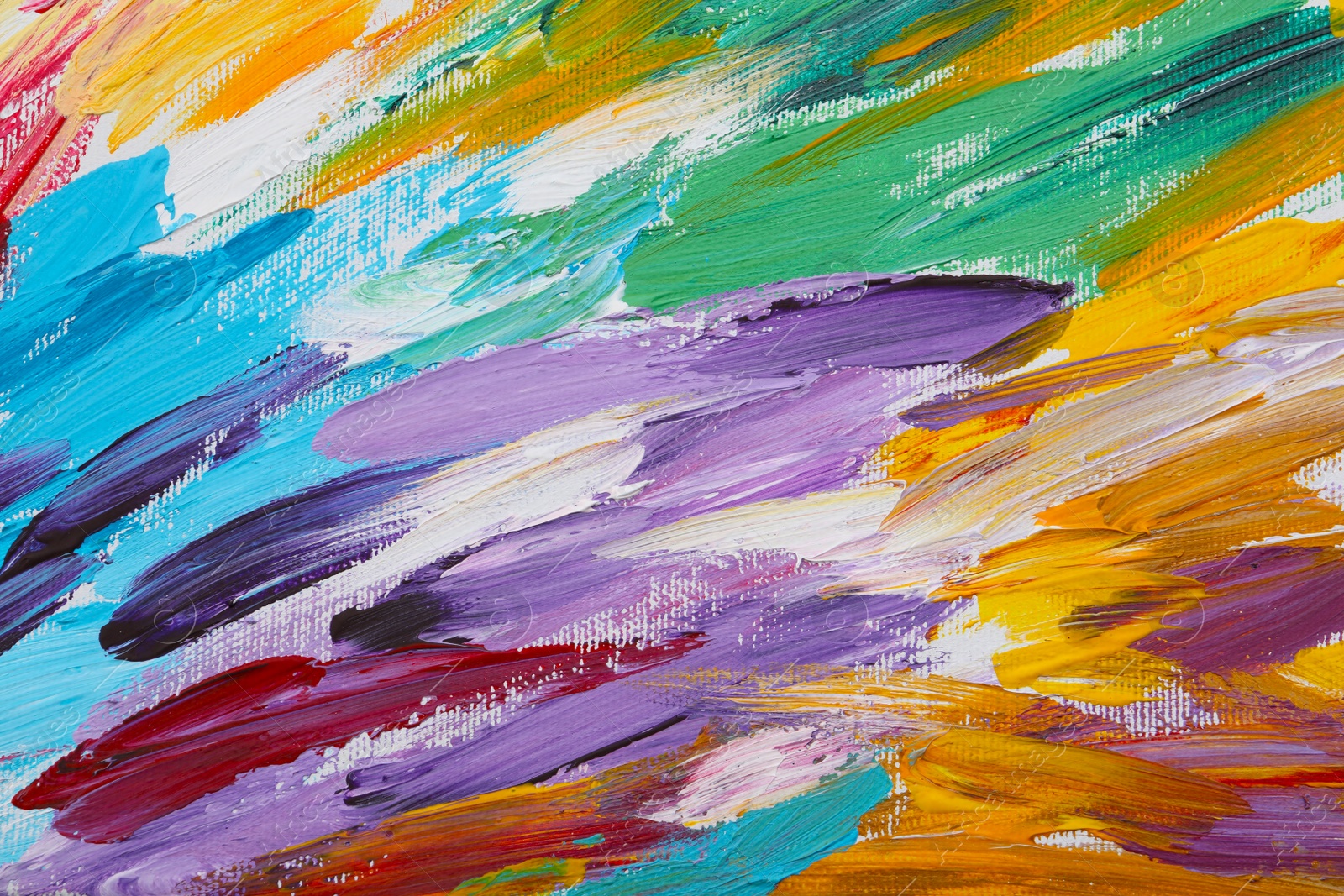 Photo of Beautiful strokes of colorful oil paints on white canvas as background, closeup