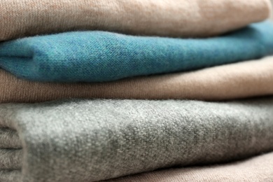 Photo of Stack of cashmere clothes as background, closeup