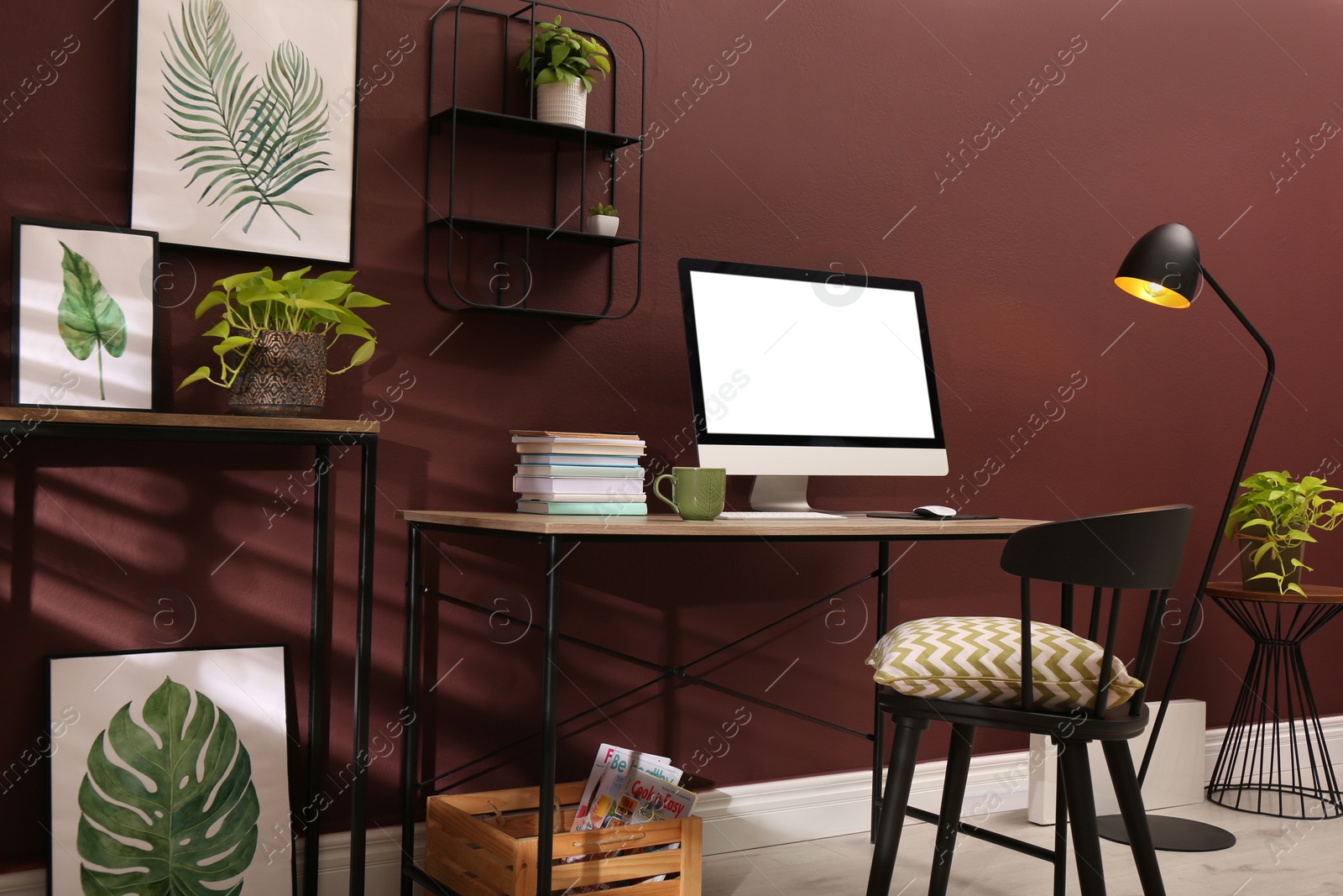 Photo of Comfortable workplace with modern computer and stylish furniture in room. Interior design