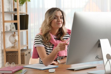 Online test. Woman studying with computer at home