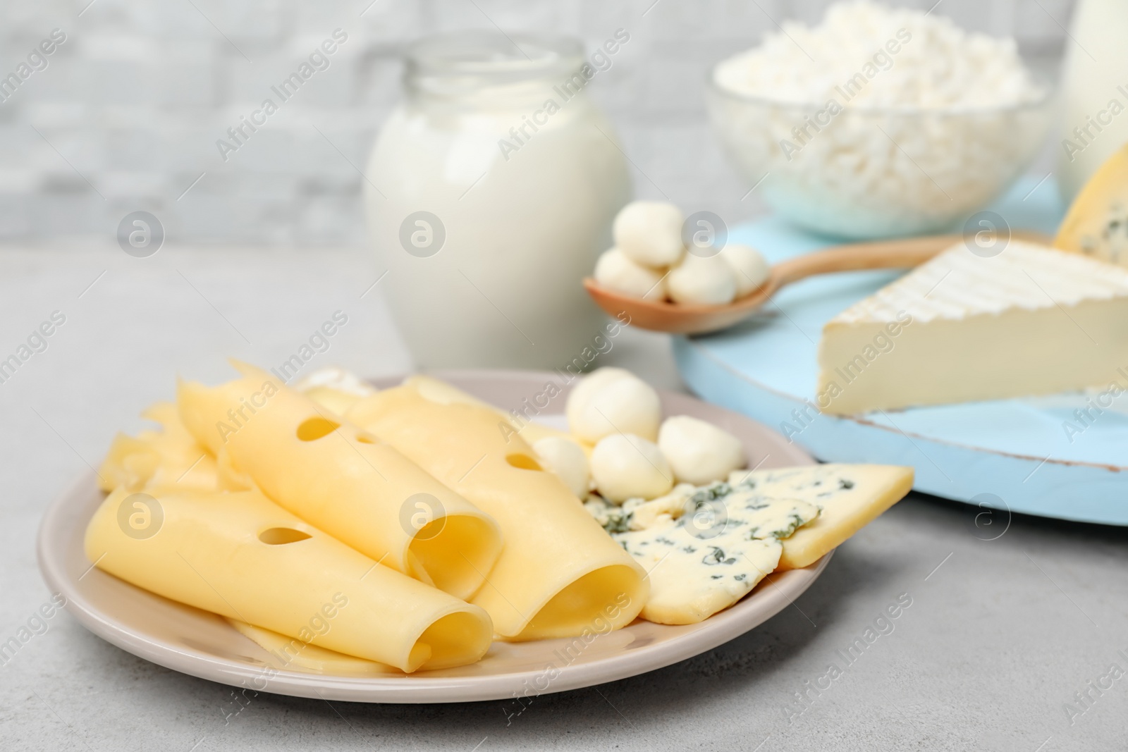 Photo of Plate with fresh dairy products on table