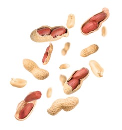 Image of Unpeeled peanuts in air on white background