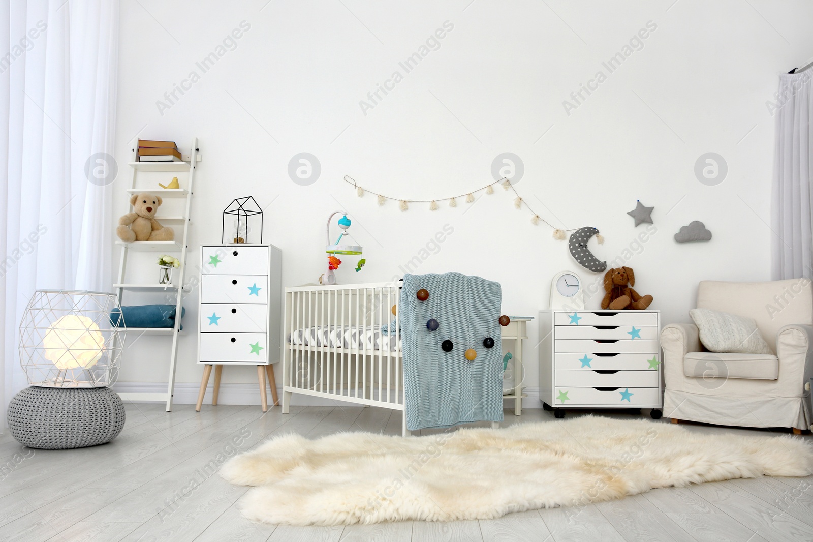 Photo of Cozy baby room interior with crib and armchair