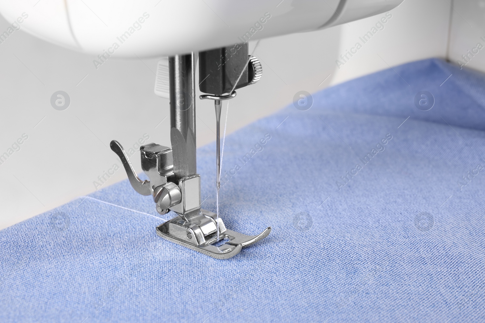 Photo of Closeup view of sewing machine with fabric