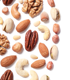 Different delicious nuts on white background, flat lay. Space for text