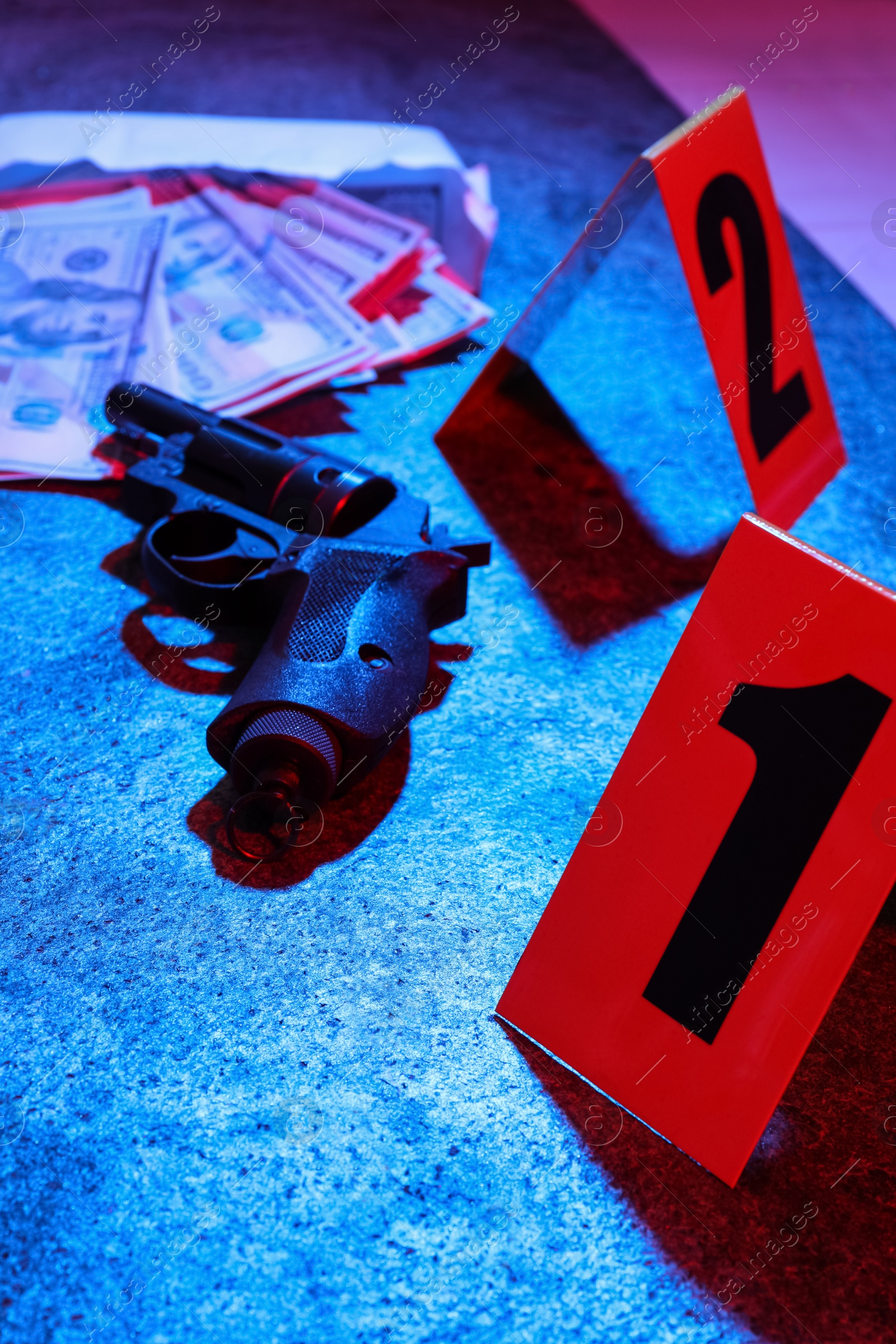 Photo of Evidences and crime scene markers on stone background, toned in red and blue