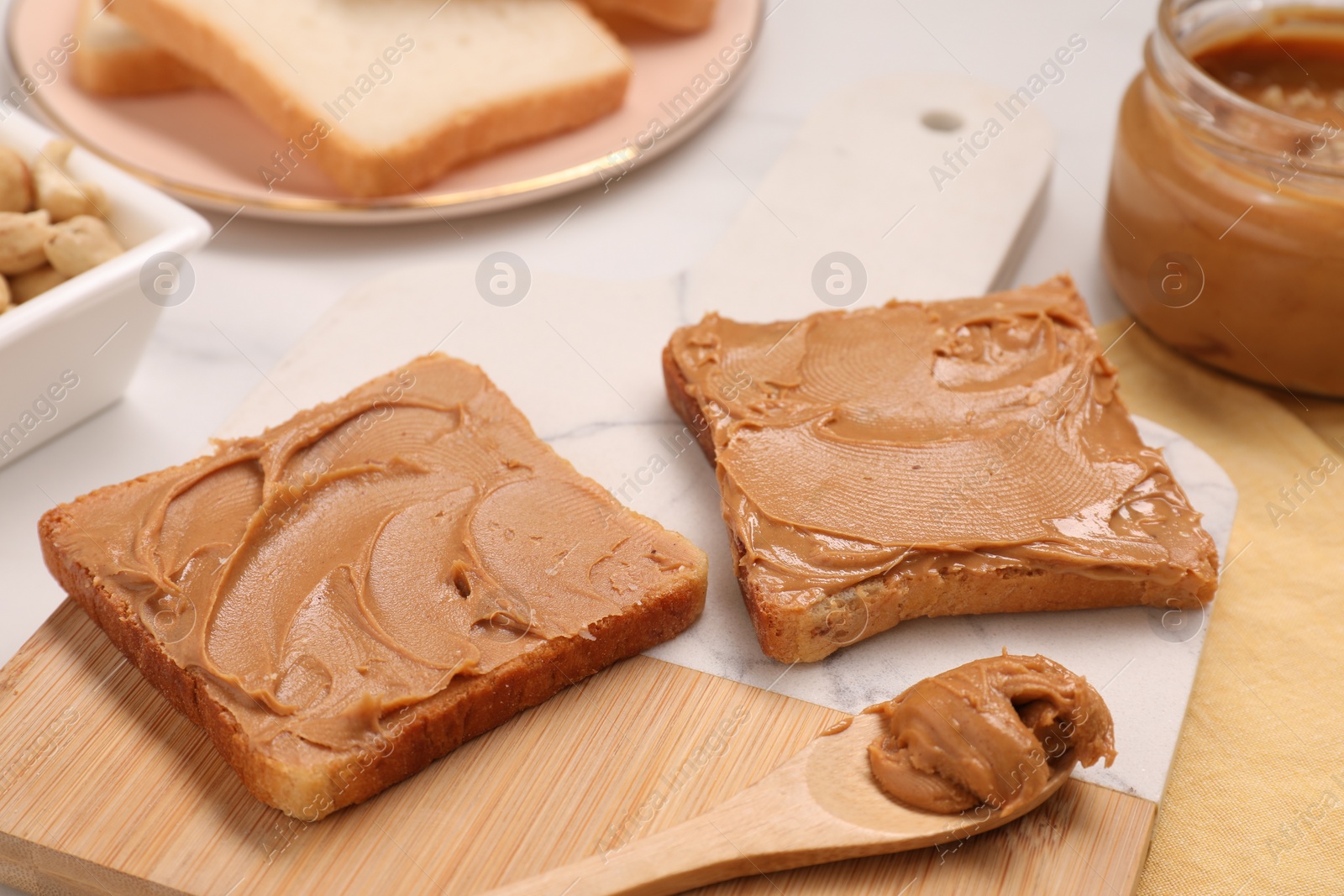 Photo of Toasts with tasty nut butter on white table