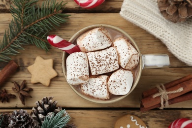 Photo of Flat lay composition with delicious marshmallow cocoa and Christmas decor on wooden table