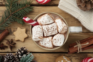 Flat lay composition with delicious marshmallow cocoa and Christmas decor on wooden table