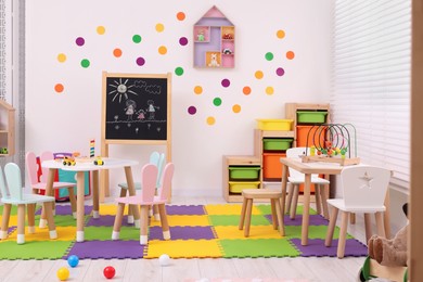 Stylish kindergarten interior with toys and modern furniture