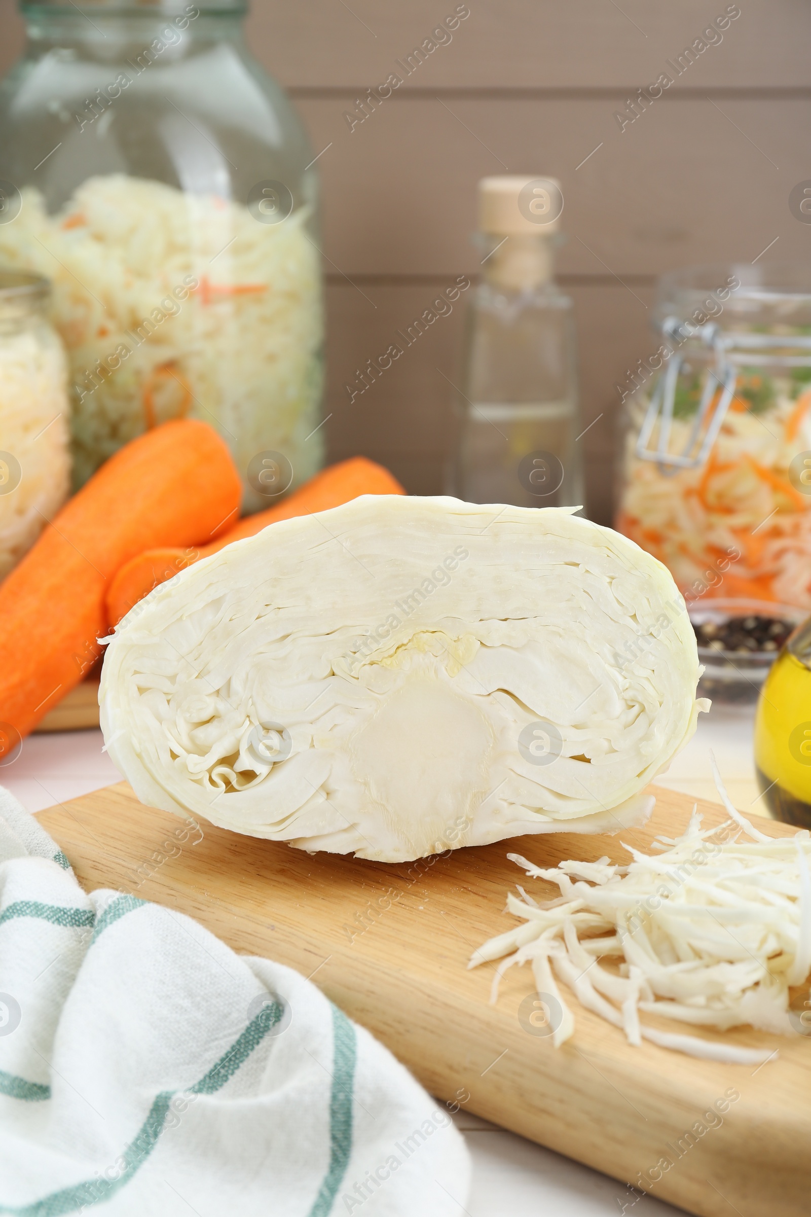 Photo of Cooking delicious sauerkraut soup. Fresh chopped cabbage and ingredients on white table