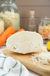 Photo of Cooking delicious sauerkraut soup. Fresh chopped cabbage and ingredients on white table