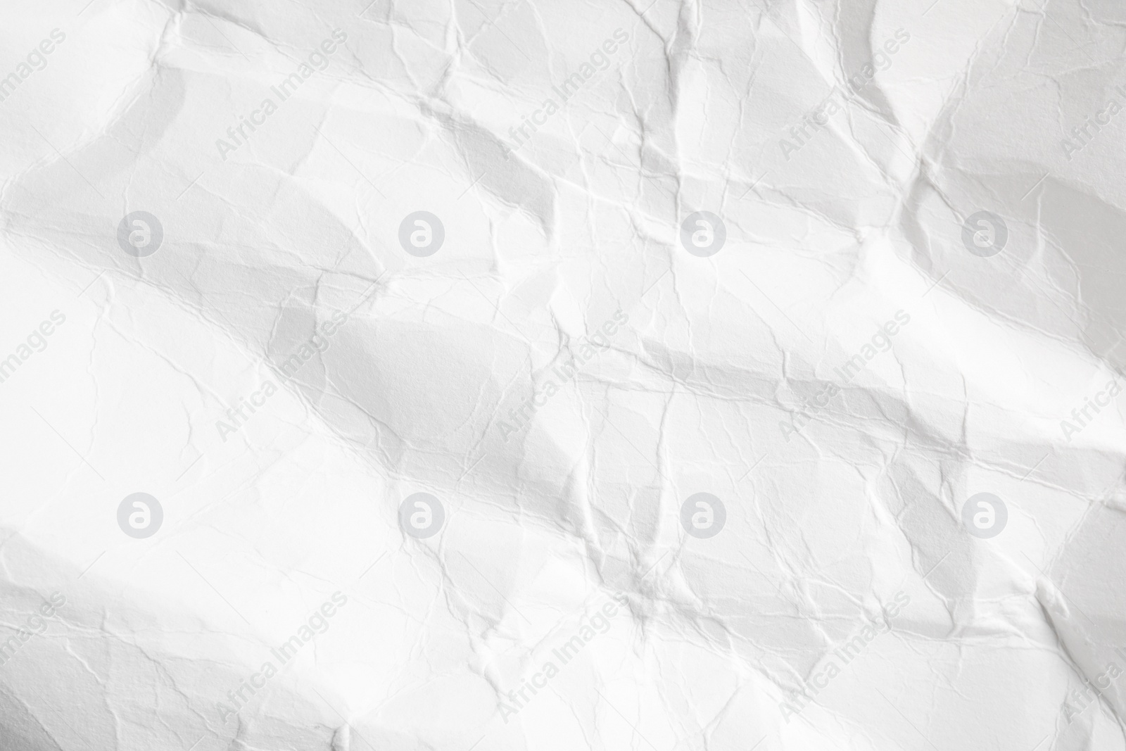 Photo of Crumpled white paper sheet as background, closeup