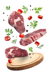 Beef meat, different spices and board falling on white background