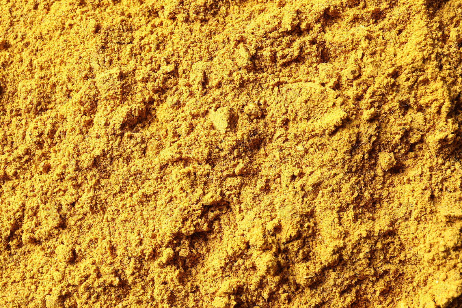 Photo of Dry curry powder as background, top view