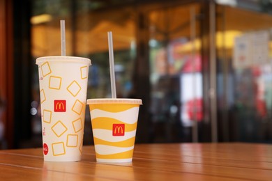 Photo of MYKOLAIV, UKRAINE - AUGUST 11, 2021: Cold McDonald's drinks on table in cafe. Space for text