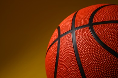 Photo of Basketball ball on color background, closeup. Space for text