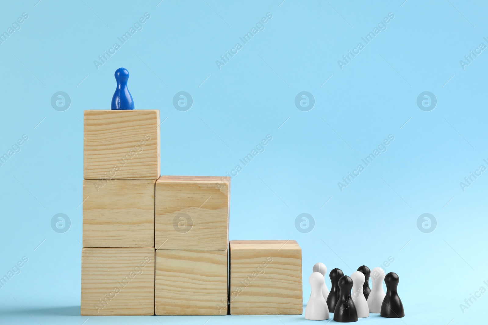 Photo of Block staircase and color game pieces on light blue background, space for text. Career promotion concept