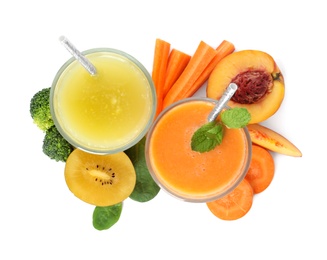 Photo of Glasses of delicious juices and fresh ingredients on white background, top view