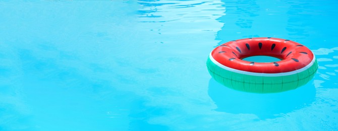 Inflatable ring in swimming pool on sunny day, space for text. Banner design