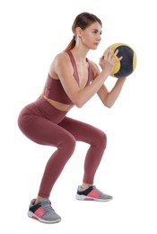 Photo of Athletic woman doing squats with medicine ball isolated on white