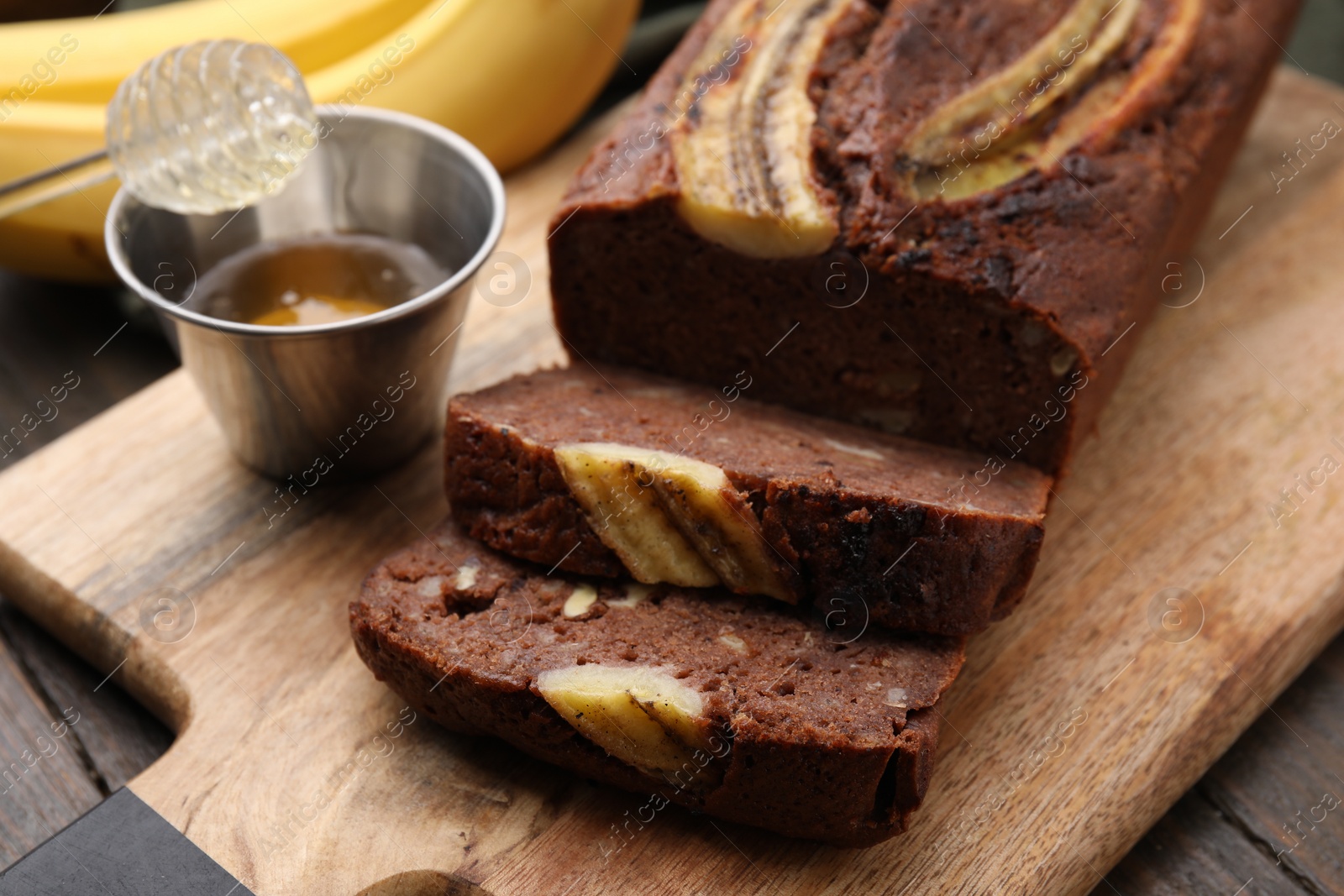 Photo of Delicious banana bread served on wooden table, closeup
