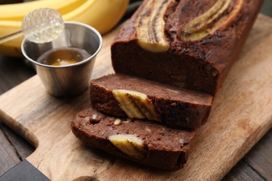 Photo of Delicious banana bread served on wooden table, closeup