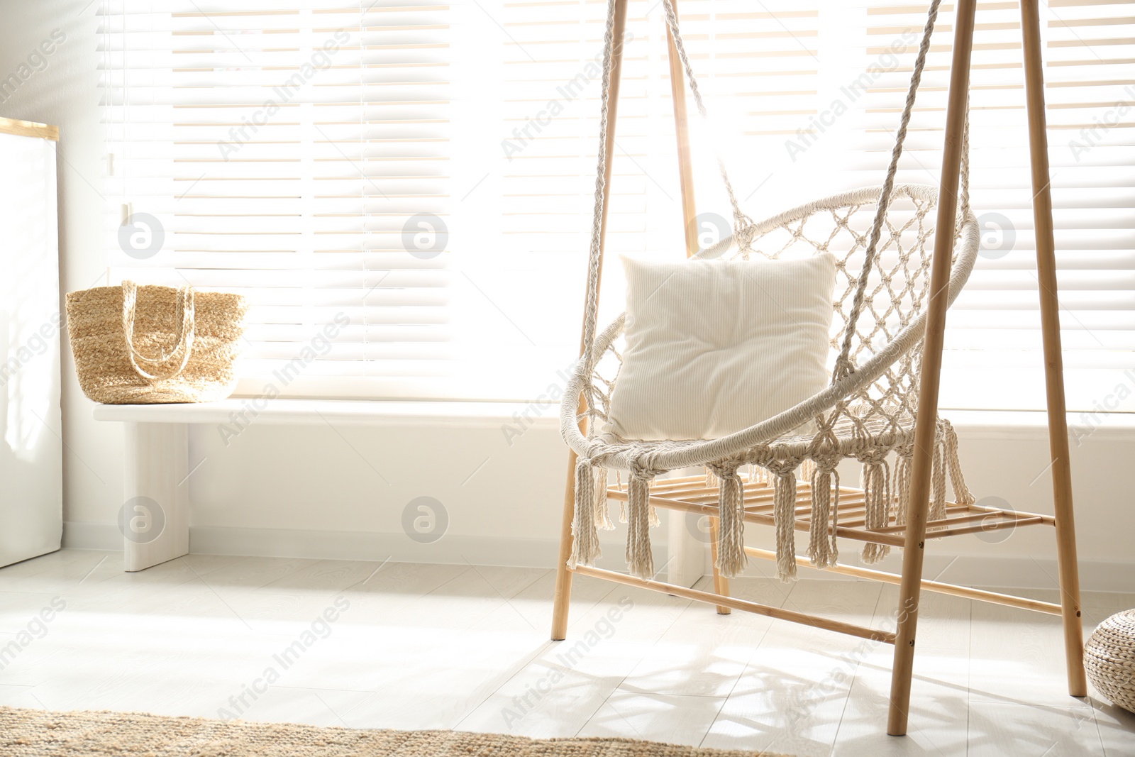 Photo of Comfortable hammock chair in stylish room. Home interior