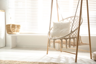 Comfortable hammock chair in stylish room. Home interior